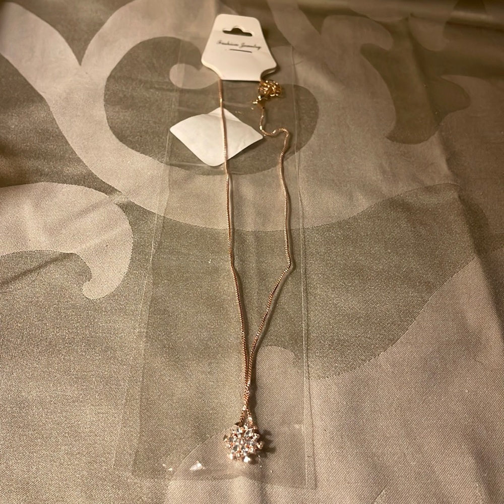 Rose gold snowflake necklace-new in package 20” long